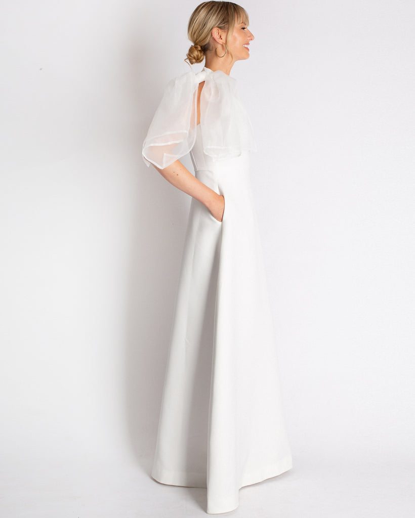 A combination of modern romantic & classic style in the Vivienne Gown. Asymmetrical, fit & flare silhouette with an effortless organza tie on the shoulder. Made in a structured material that drapes effortlessly. 
