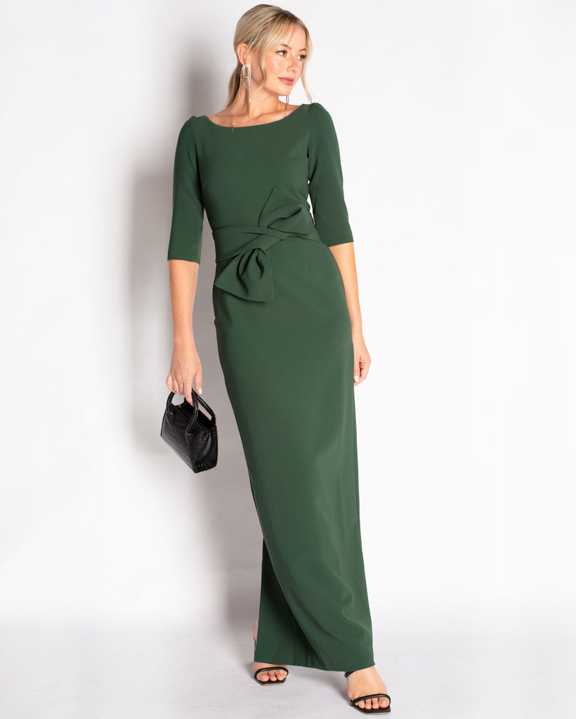A hunter green floor length gown made in a stretch crepe material that is comfortable to wear. Elegant boat neck detail with 3/4 length sleeves. This dress waist line is at natural waist with a removable sash that can be styled with or without the gown.