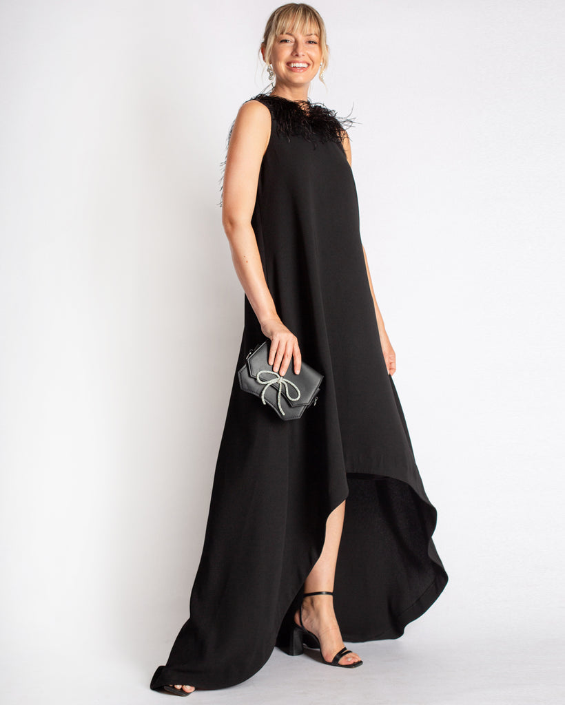 The Ginger Gown by Camilyn Beth. A statement gown that will turn heads. Tent style dress in a stretch crepe material that has an effortless drape & ostrich feather neckline detail with a scoop back. Hi-low hem to show balance the oversized nature of the gown design. 
